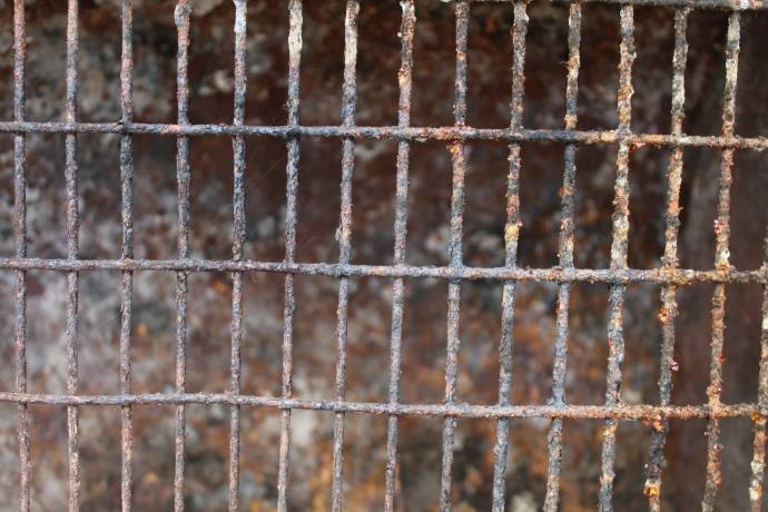 Rusty metal grating close-up, weathered and old.